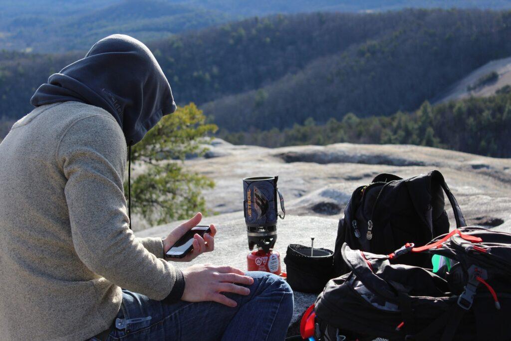 camping solo. river view. campfire. smartphone