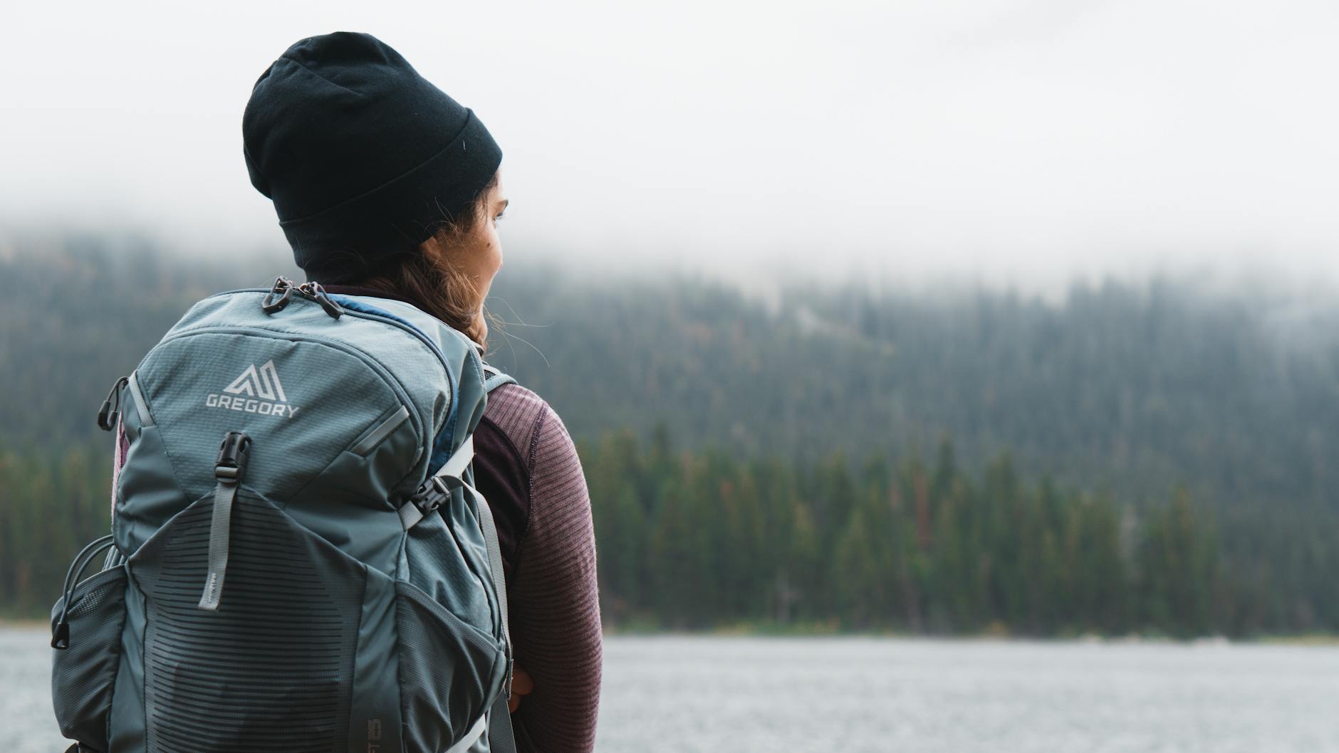close up photography of woman carrying gray backpack