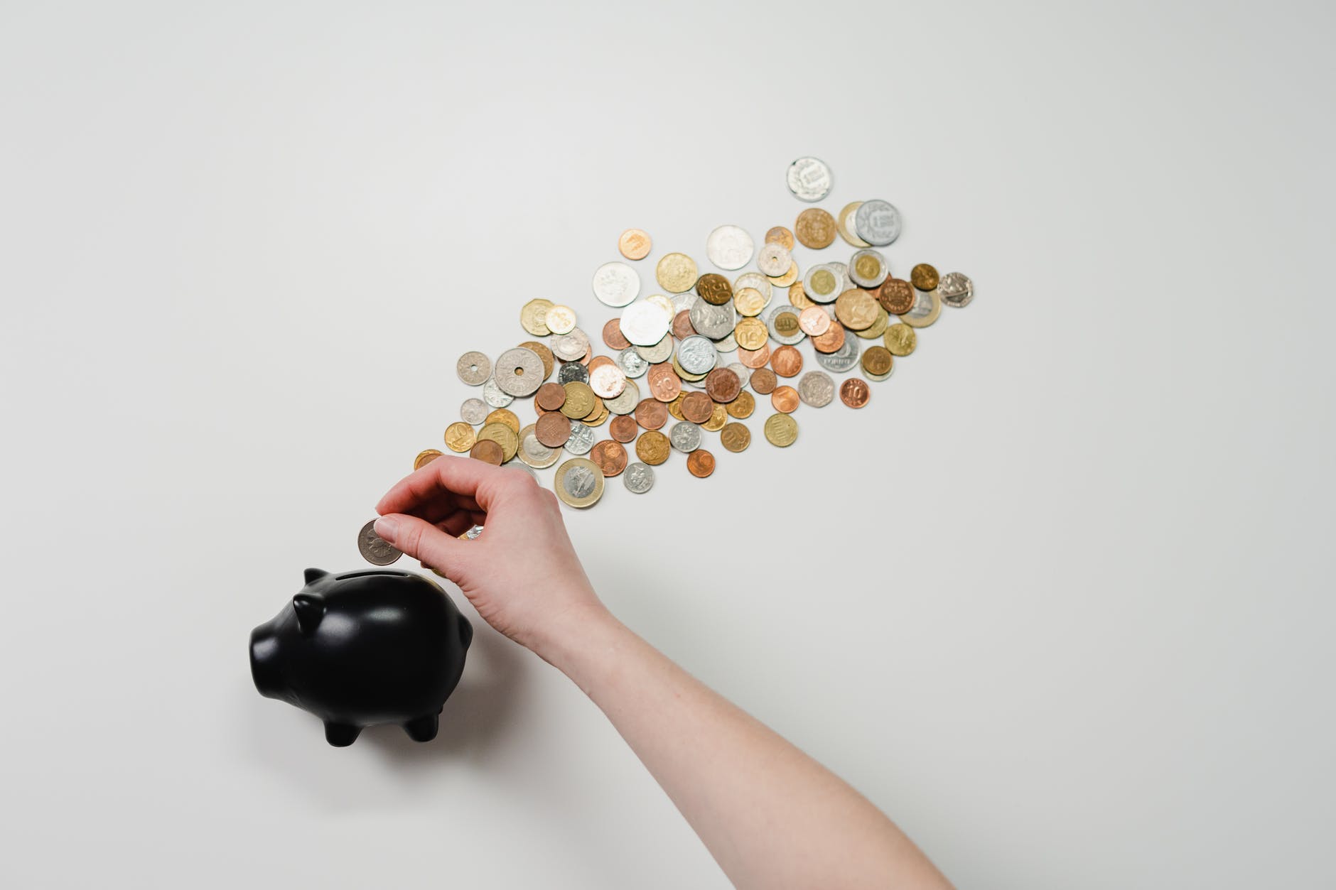 Passive income person putting coin in a piggy bank