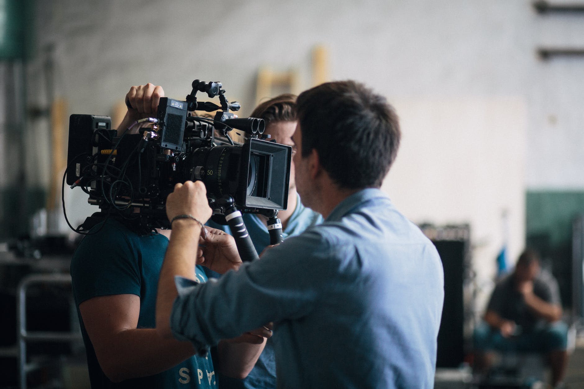 film crew people fixing a video camera while on set