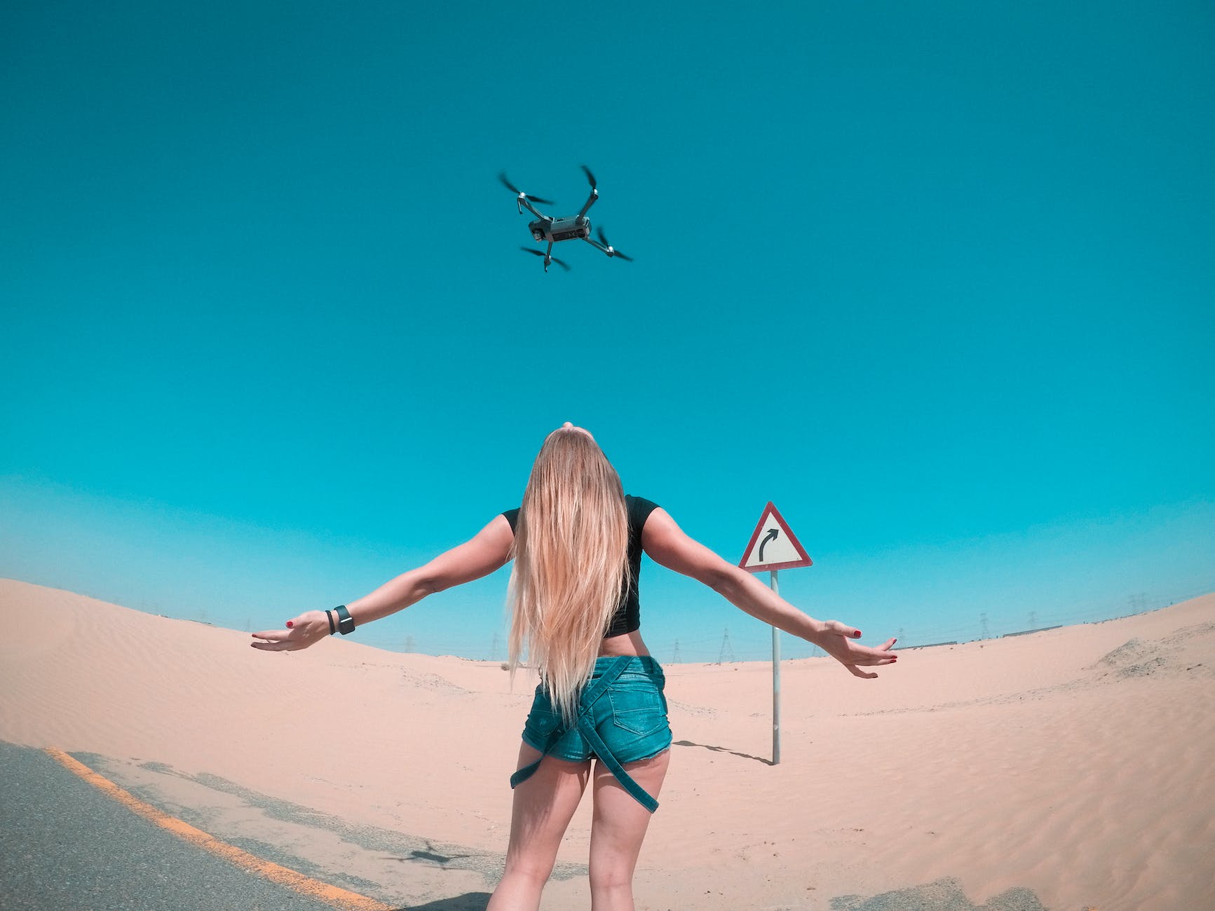 Drones black quadcopter over woman wearing black shirt