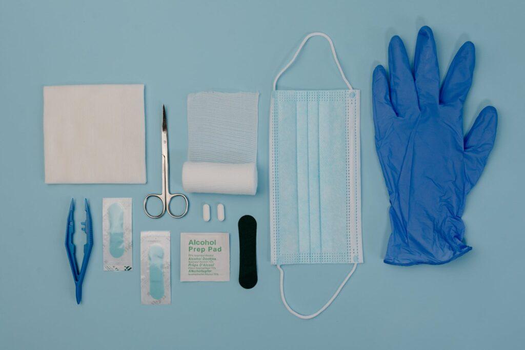 a set of first aid kit tools on blue surface