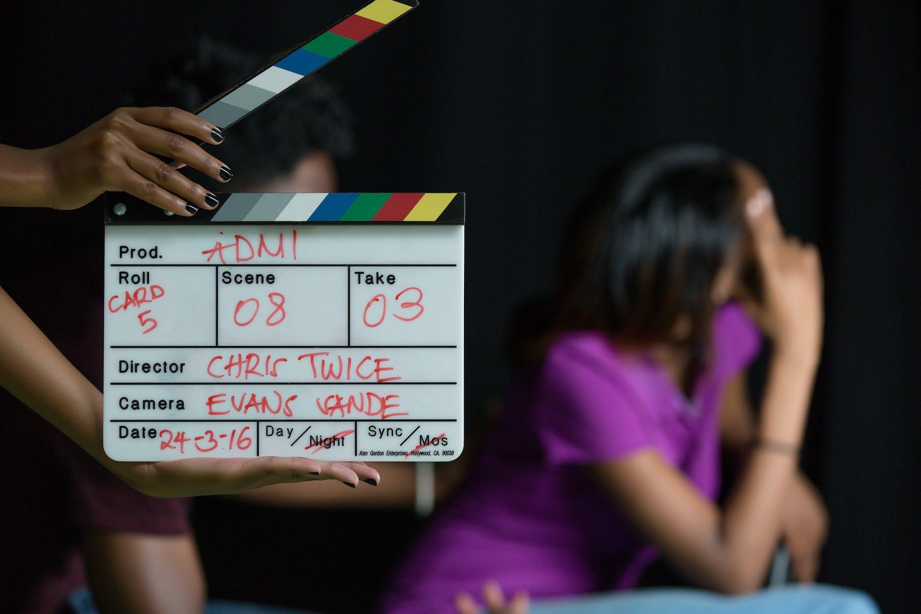 person holding a clapperboard on a movie set