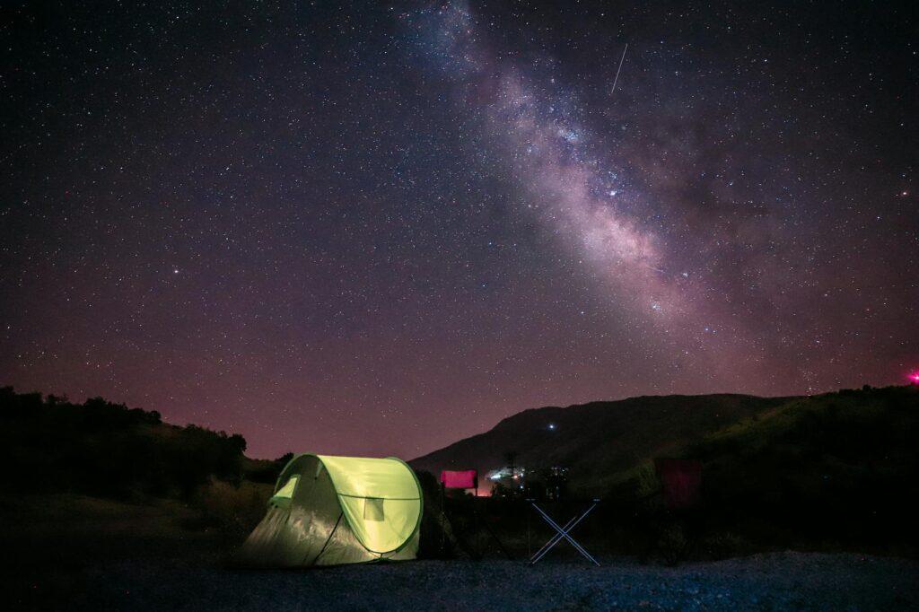 tent on the ground under beautiful milky way