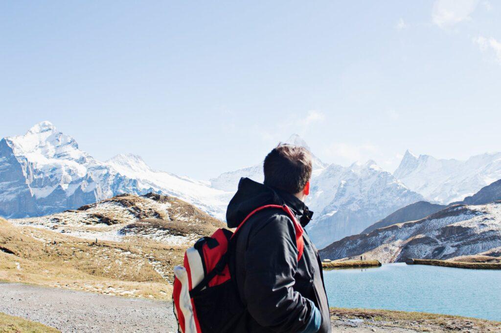 The Ultimate Backpacking Checklist for Epic Hiking Trips man in black jacket standing near body of water