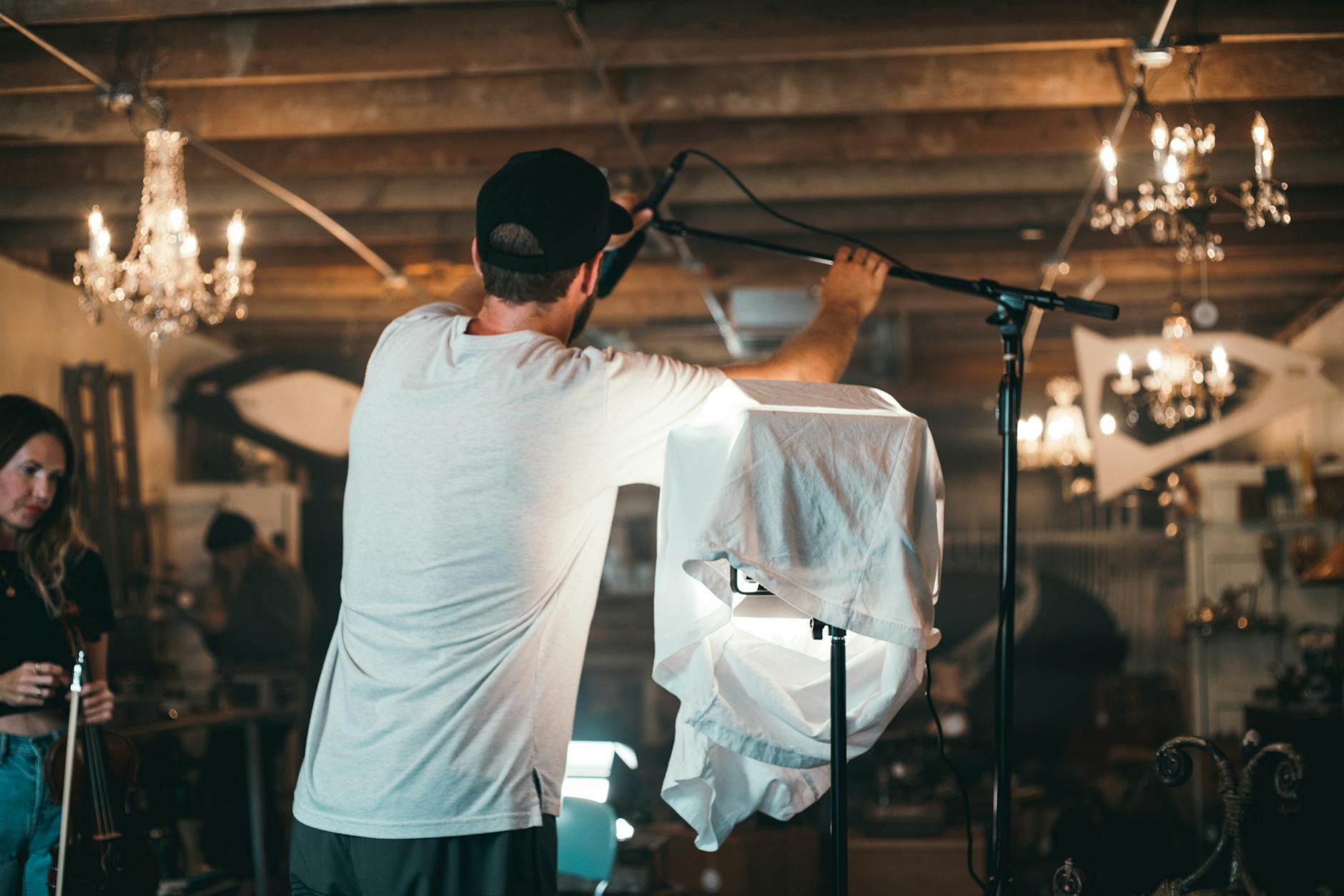 man fixing microphone with stand