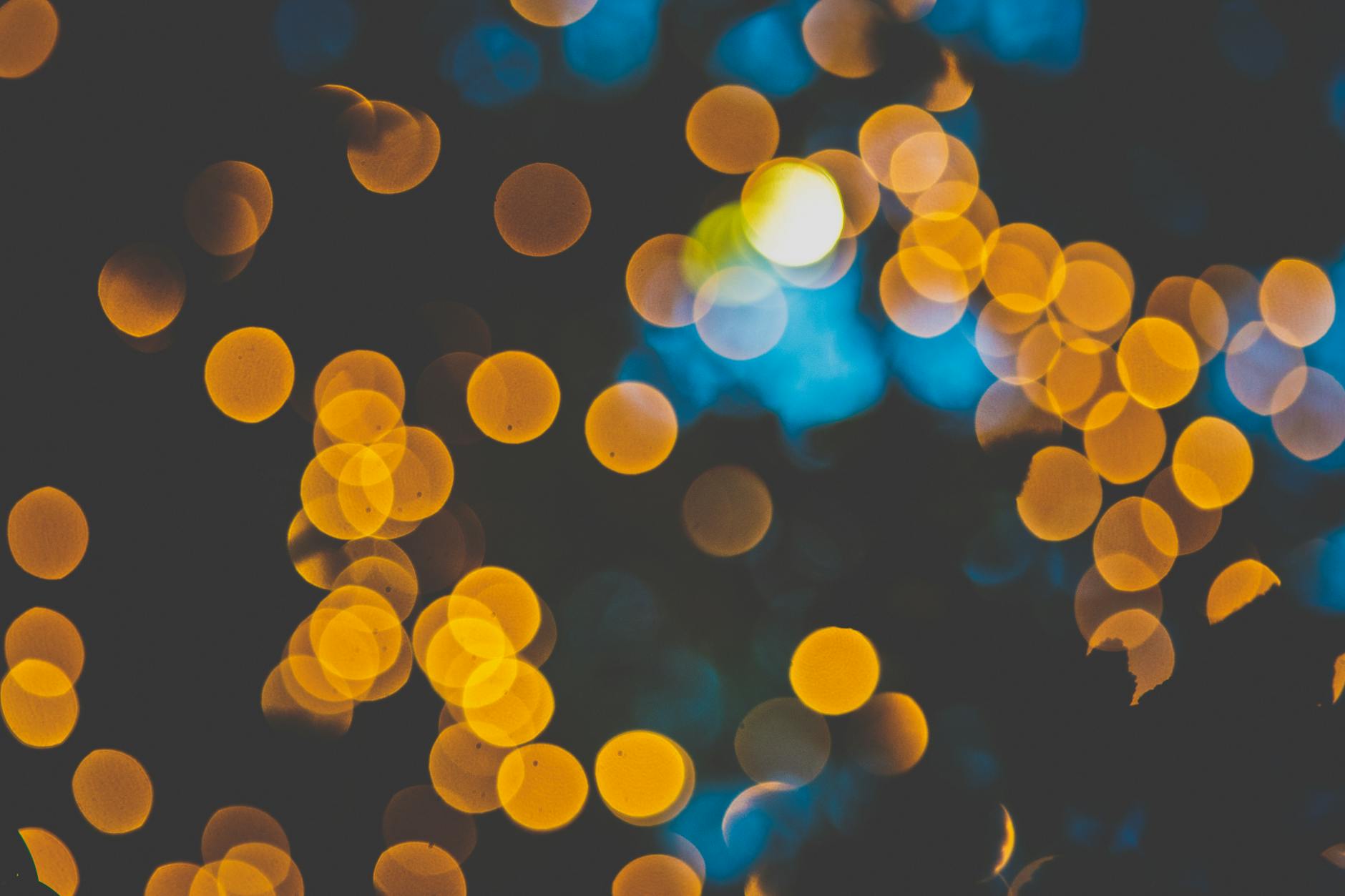 Close-up of vibrant yellow bokeh lights, creating a mesmerizing and atmospheric effect.