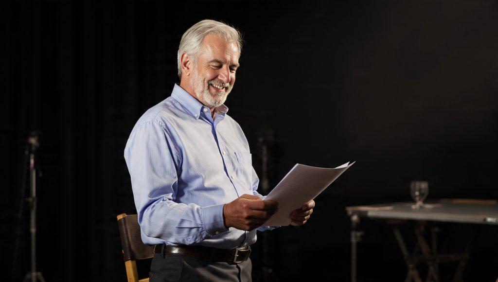 Older Actor Portraits: "Actor in their 50s auditioning for a role", "Mature actor holding script and smiling"