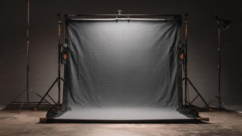Matthews 4x4 Floppy Frame with unbleached muslin, black floppy sides, C-stand hardware, professional grip equipment product photography on a dark studio background, high detail, 16:9 aspect ratio