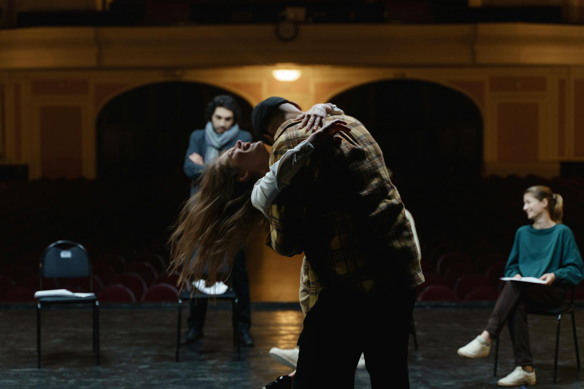 man hugging a woman on stage