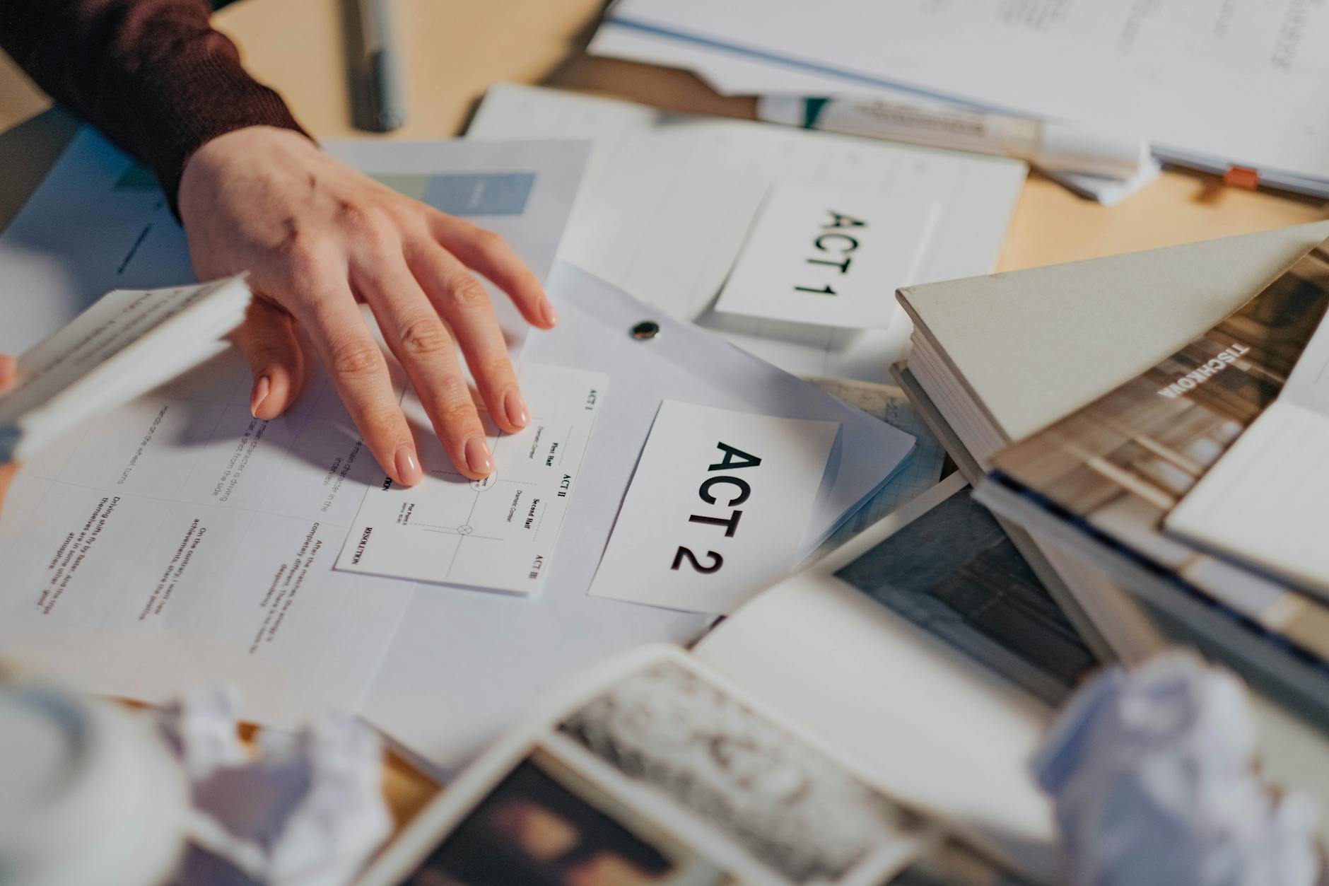 person holding white printer paper - Breaking Free from Actor's Block: Tips to Revitalize Your Performance