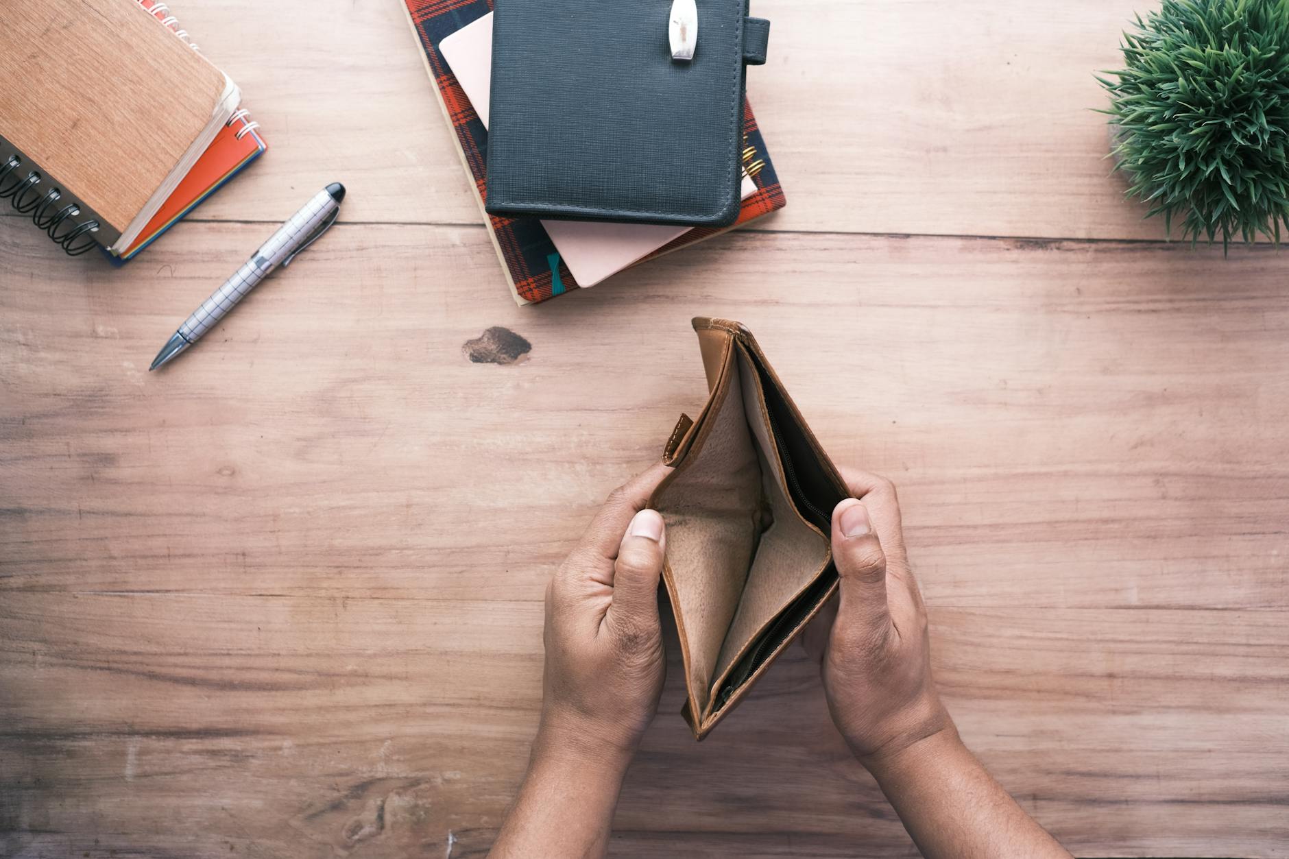 person holding an empty wallet