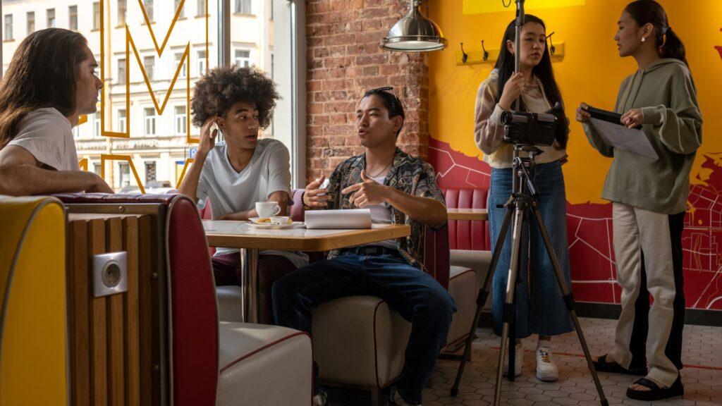 photos of directors giving feedback, talking with actors, or actors rehearsing building trust