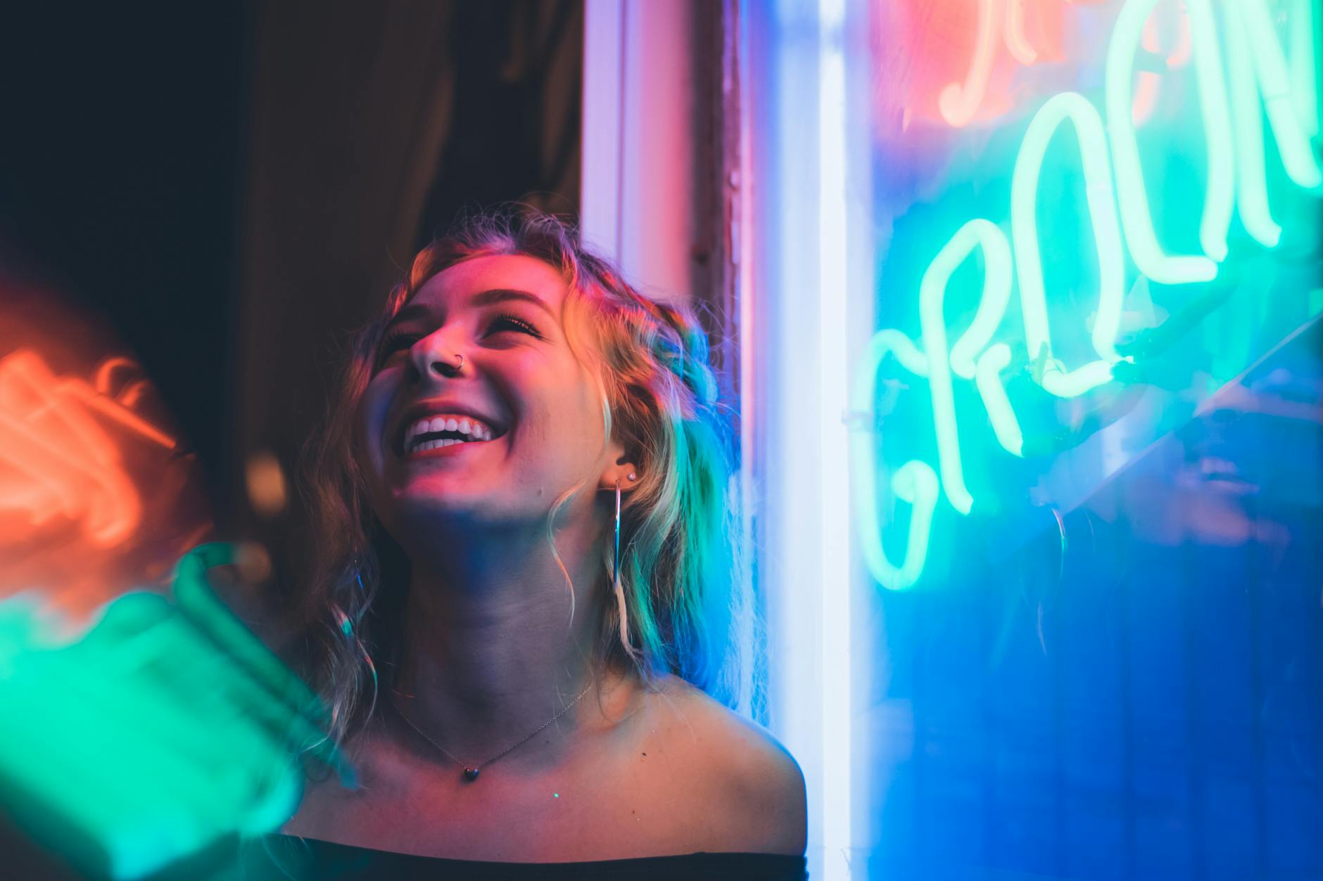 nightlife travel filmmaking woman smiling near glass window