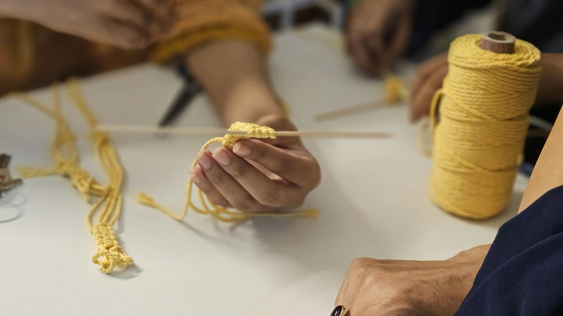 travel b-roll close up of hand crafting with yellow yarn