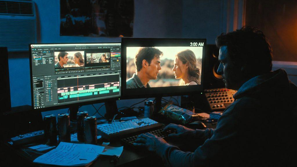 Wide shot of a filmmaker sitting alone at 3:00 AM in a dark editing suite, face lit by a dual-monitor setup showing DaVinci Resolve timeline. Visible on-screen: color-graded footage of two actors in a dialogue scene. Empty energy drink cans, a notepad with scribbled notes ('Fix audio buzz - Scene 7?'), and a bag of chips. Cold, tired, but focused expression. Cinematic blue-and-orange color grade.